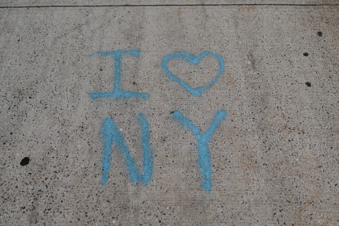 a blue sign on a concrete surface
