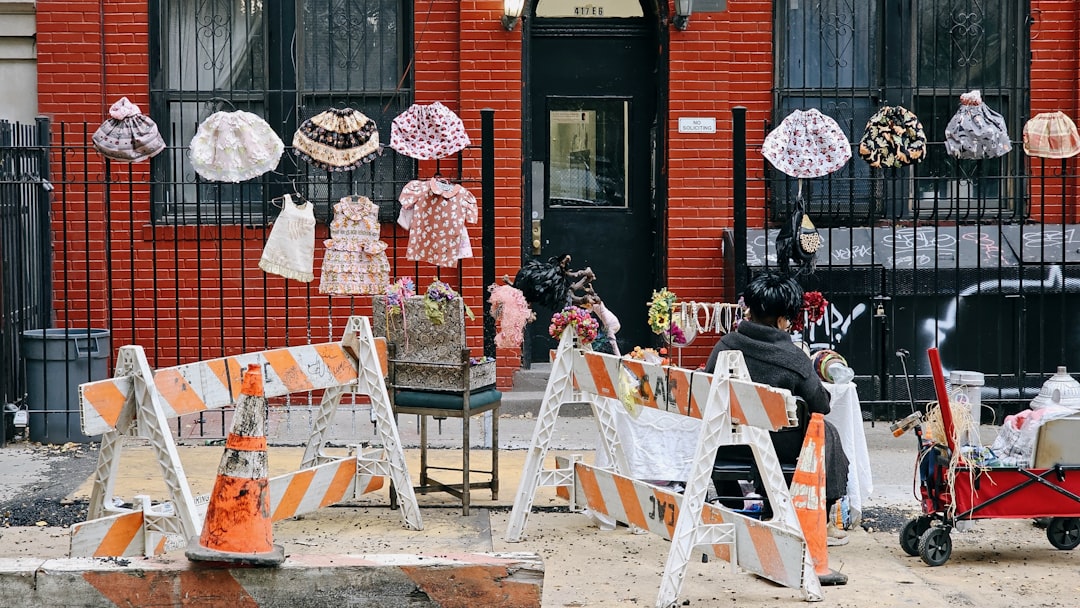 a woman sitting on a chair in front of a red brick building