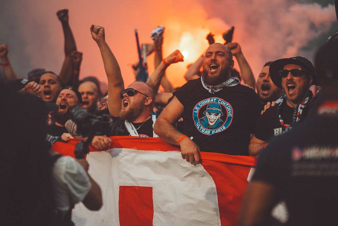 a group of people holding a flag and cheering