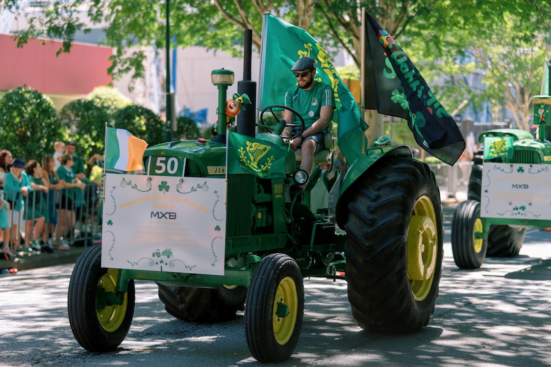Green tractor with irish flags in a parade